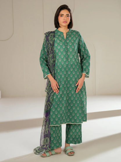 Woman wearing a green traditional outfit with a matching dupatta on a neutral background