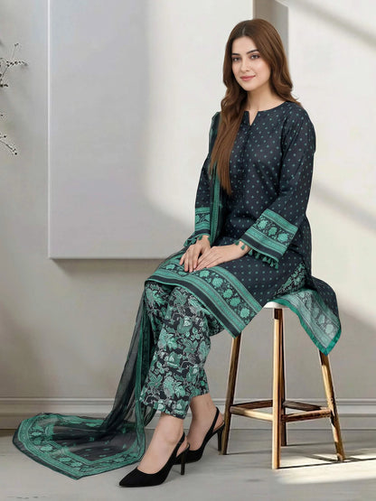 Woman wearing a green and black traditional outfit sitting on a stool.