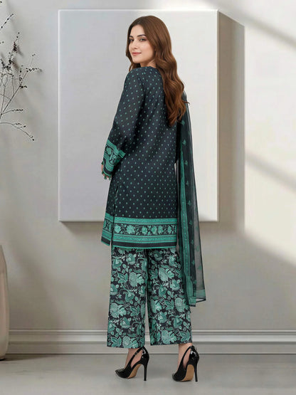Woman wearing a green and black traditional outfit with a matching dupatta in a minimalistic setting.