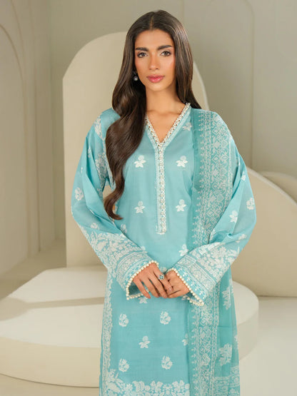 Woman wearing a light blue embroidered dress sitting on a white chair.