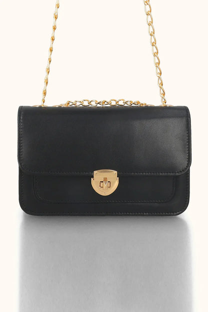Black handbag with a gold chain strap on a white background