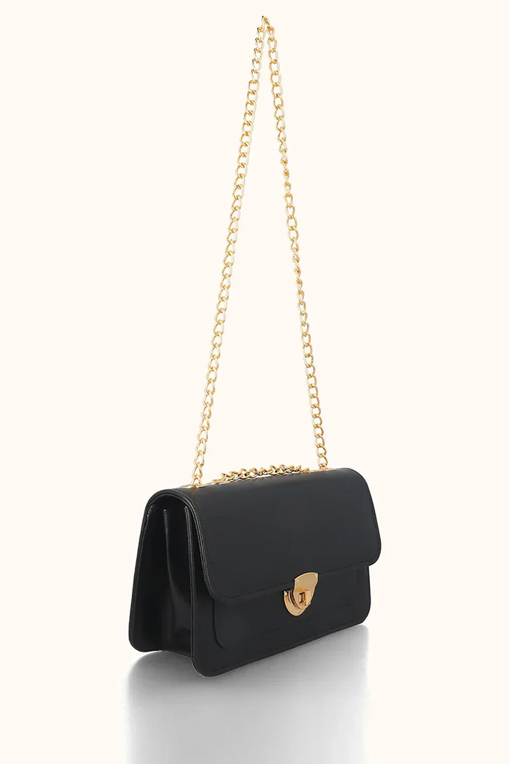 Black handbag with a gold chain on a white background