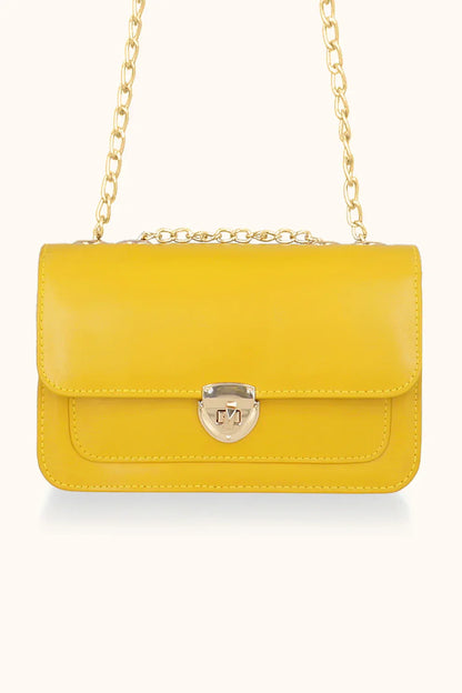 Yellow handbag with a gold chain on a white background