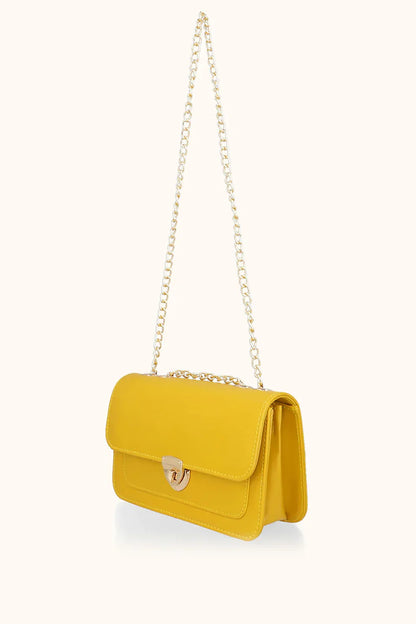 Yellow handbag with a chain strap on a white background