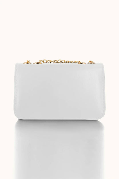 Light blue handbag with a gold chain on a white background