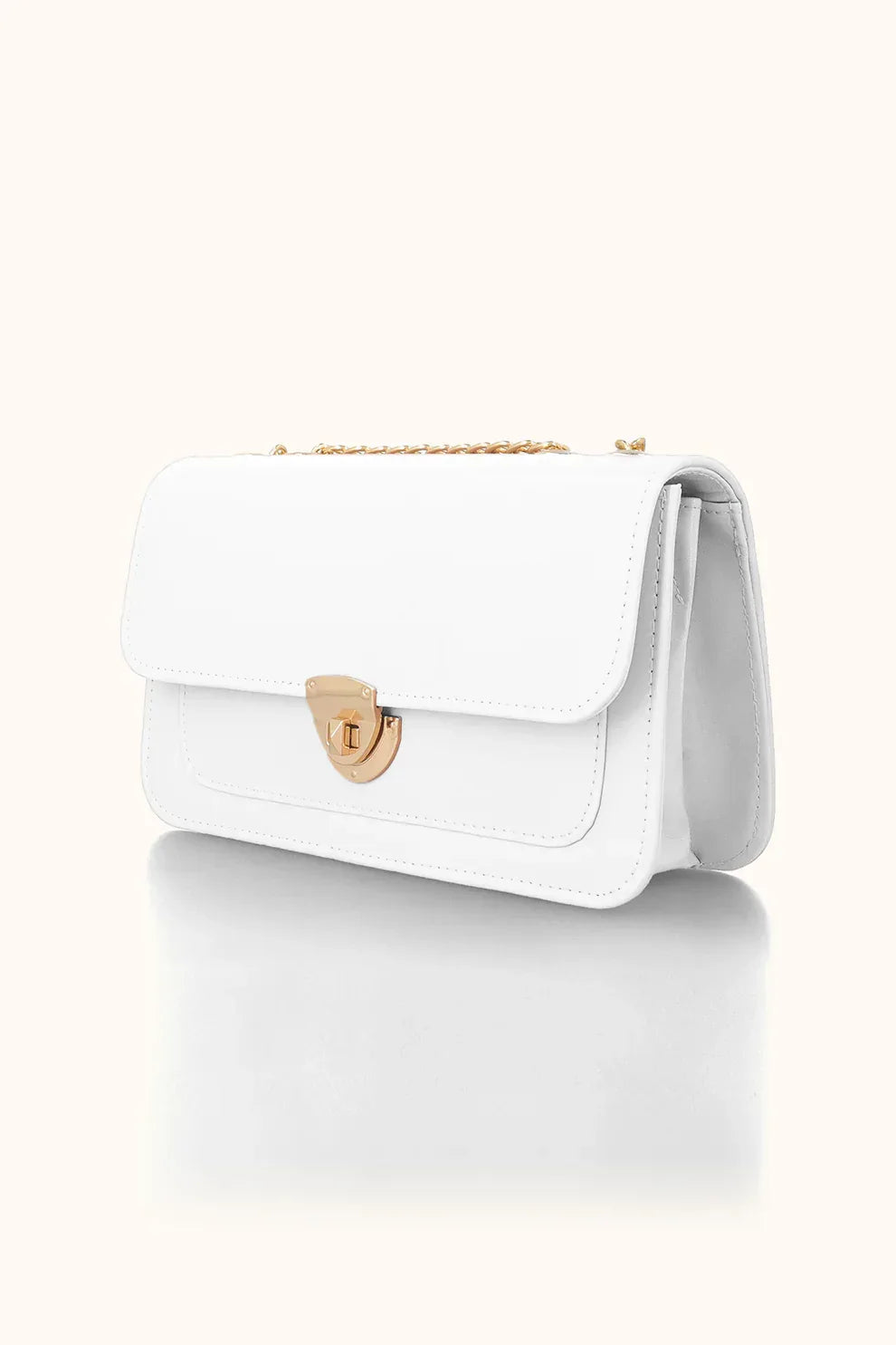 White handbag with a gold clasp on a white background