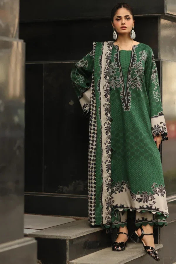 Woman wearing a green and white patterned outfit standing on steps.