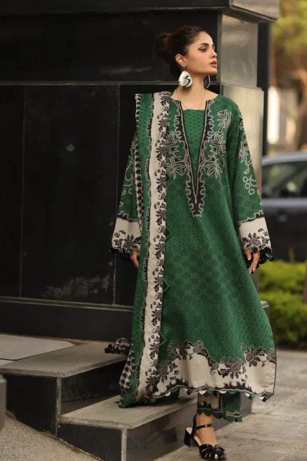 Woman wearing a green embroidered outfit standing outdoors.