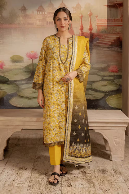 Woman in a yellow and black traditional outfit standing in front of a decorative wall with lily pads.