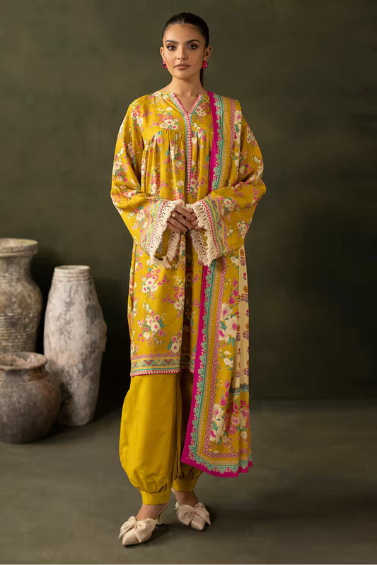 Woman wearing a yellow embroidered traditional outfit with a dark background