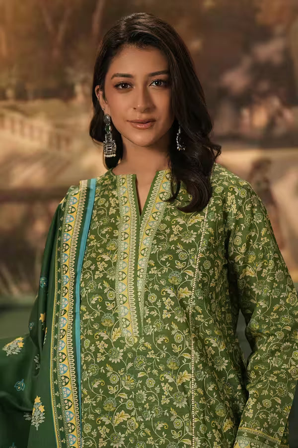 Woman wearing a green traditional outfit with floral patterns against a blurred background
