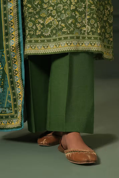 Green traditional outfit with floral patterns and brown shoes on a dark background
