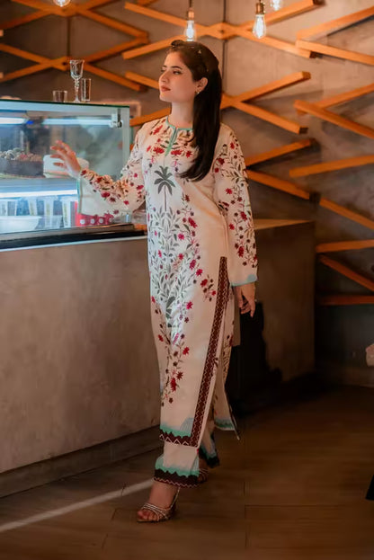 Woman in a floral dress standing in a modern interior setting