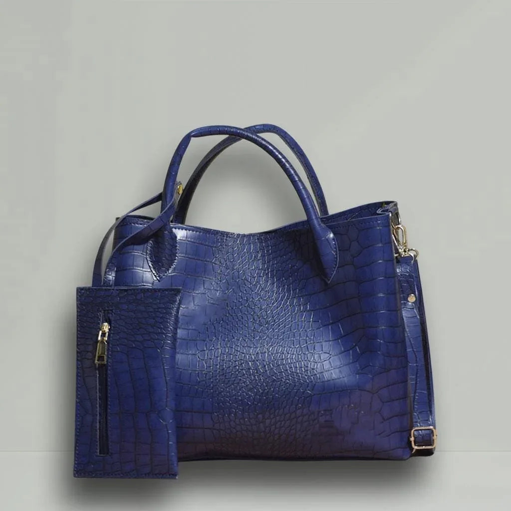 Blue textured handbag with matching pouch on a light gray background