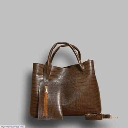 Brown crocodile-patterned handbag on a gray background