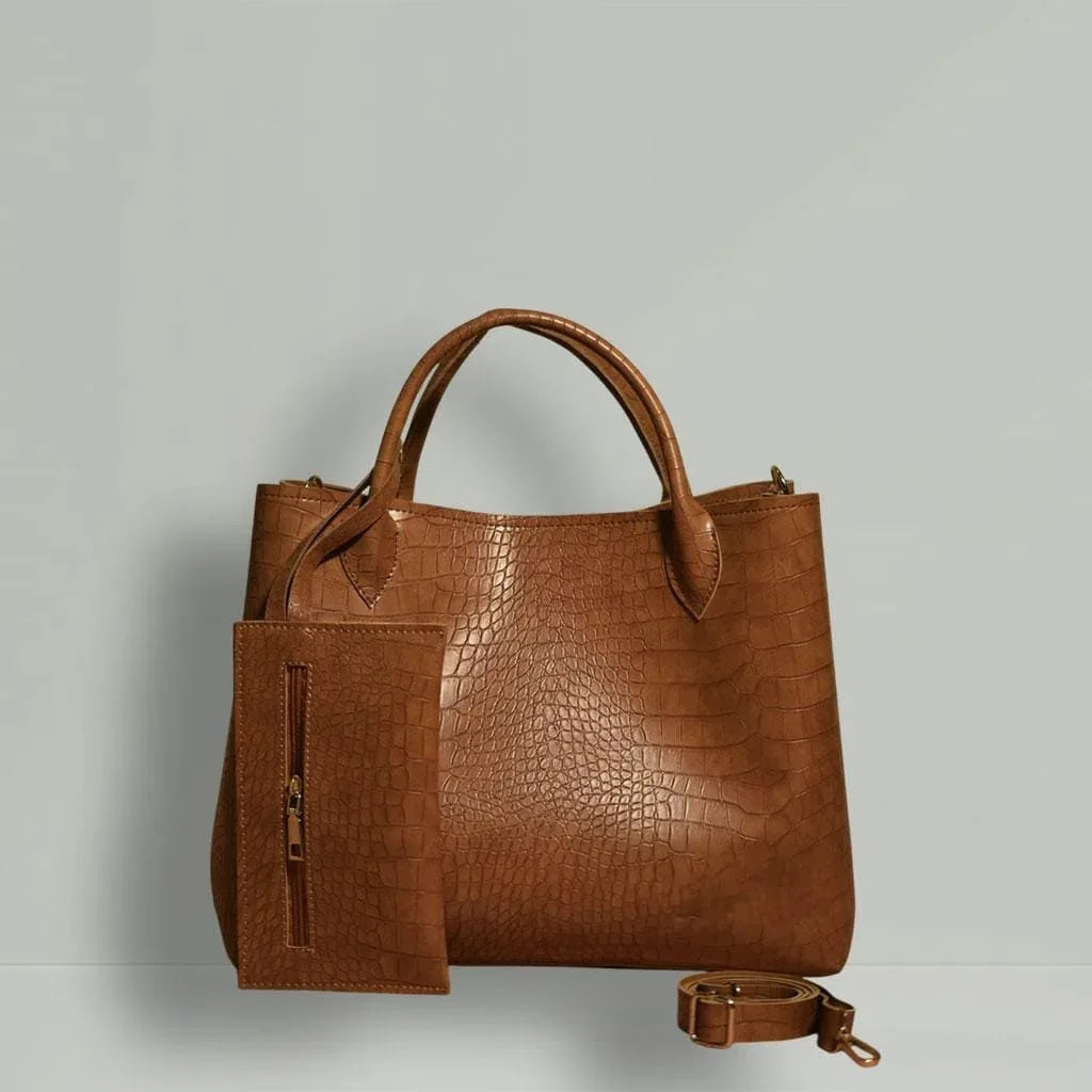 Brown leather handbag with matching pouch on a light gray background