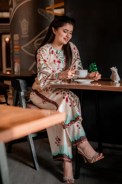 Woman in a floral dress sitting at a table in a restaurant.