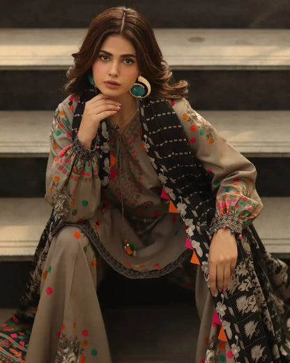 Woman wearing a colorful traditional outfit with intricate patterns.