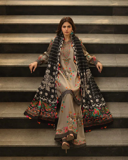 Woman in traditional embroidered outfit standing on steps