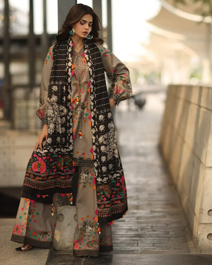 Woman wearing a traditional embroidered outfit with a scarf in an urban setting