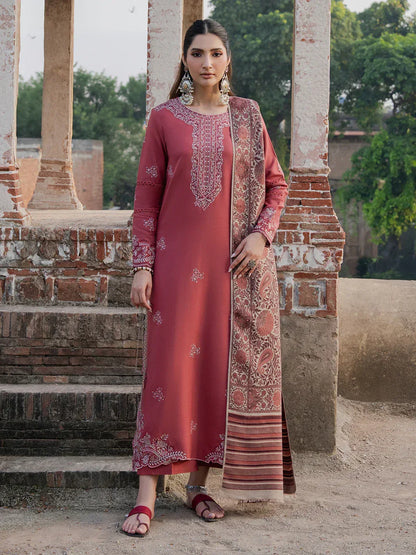 Woman in a traditional outfit standing outdoors with architectural elements in the background