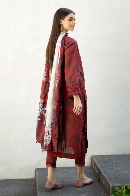 Woman wearing a red floral dress with a matching shawl on a white background