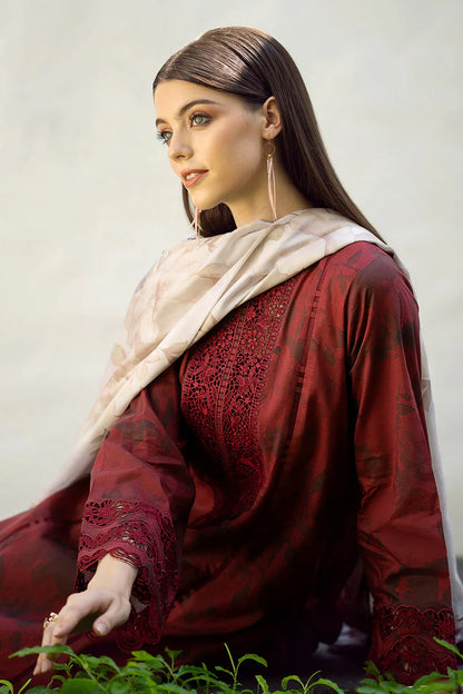 Woman wearing a red traditional outfit with a beige scarf against a plain background