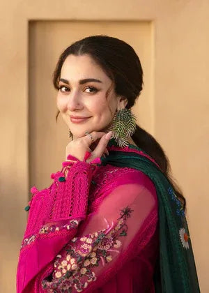 Woman wearing a pink traditional outfit with floral patterns against a beige background