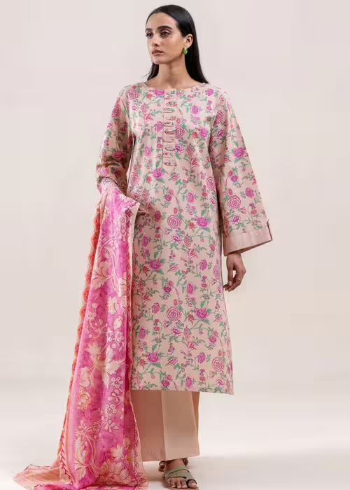 Woman wearing a floral kurta with a pink dupatta on a white background