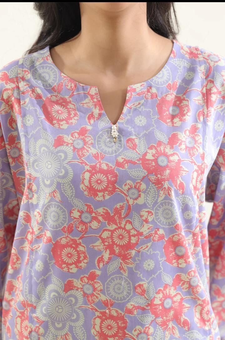 Floral patterned top with a zipper detail on a plain background