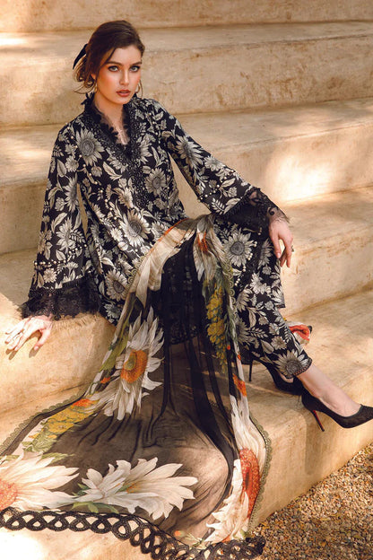 Woman sitting on stone steps wearing a floral dress with a black and white pattern.