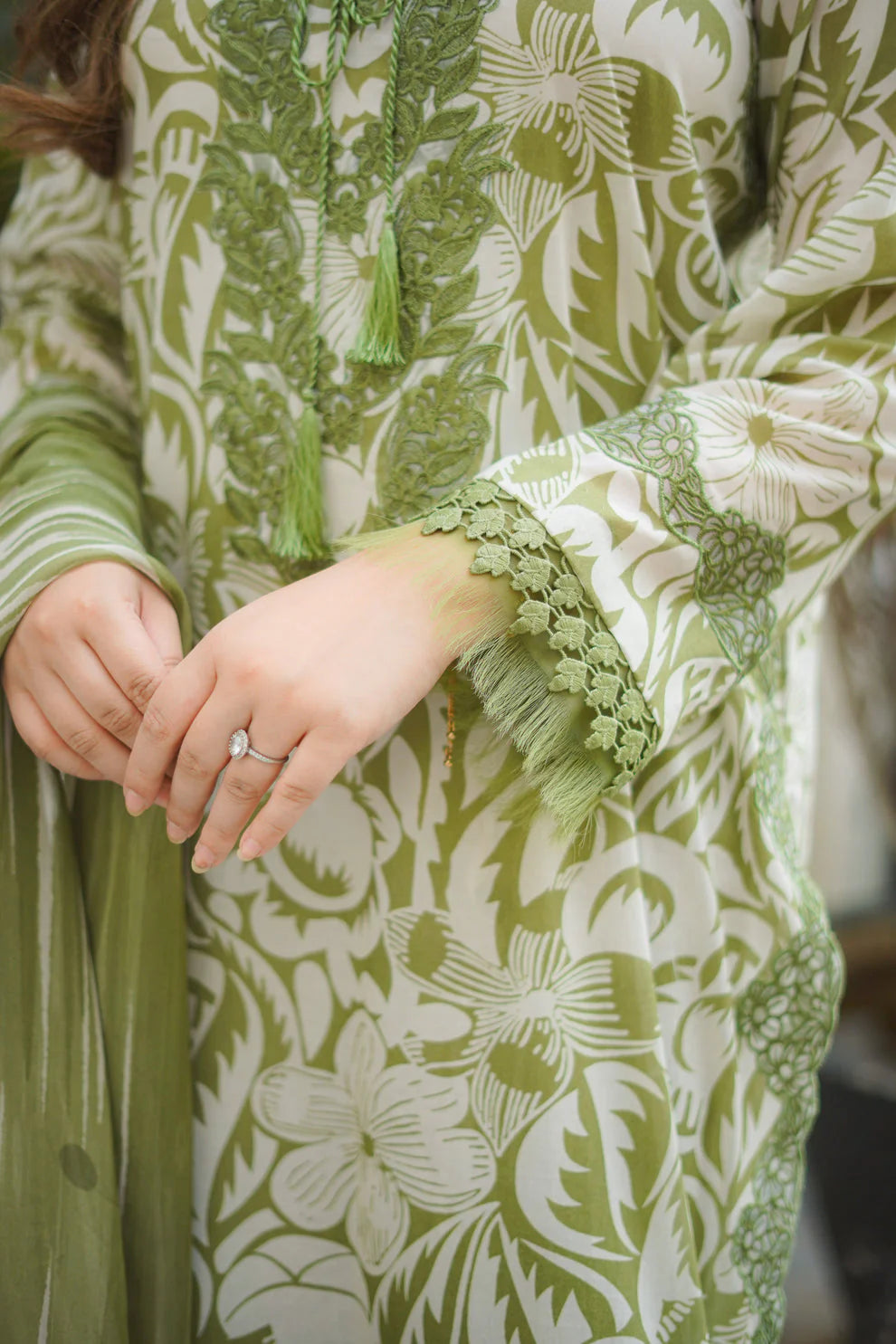 Green and white floral patterned garment with lace details