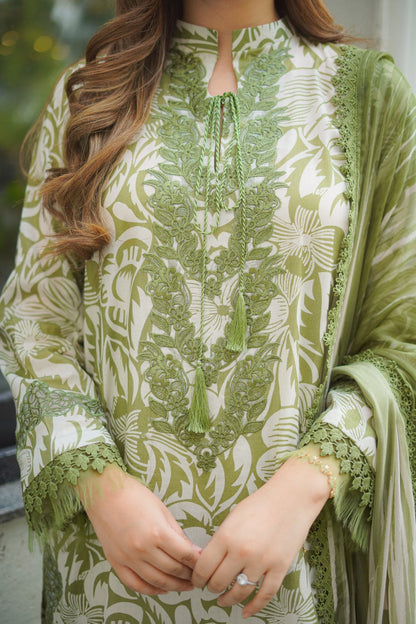 Person wearing a green and white patterned kurta with a dupatta.