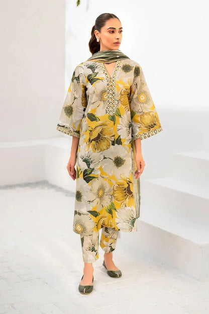 Woman wearing a floral dress with a green scarf in a minimalistic setting