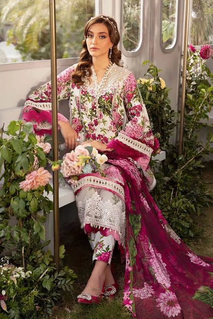 Woman in a floral and embroidered outfit sitting among flowers and greenery.