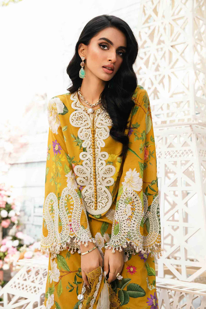 Woman wearing a yellow floral dress with intricate white embroidery against a decorative white background.