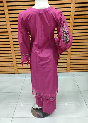 Pink traditional outfit with embroidery on a wooden background