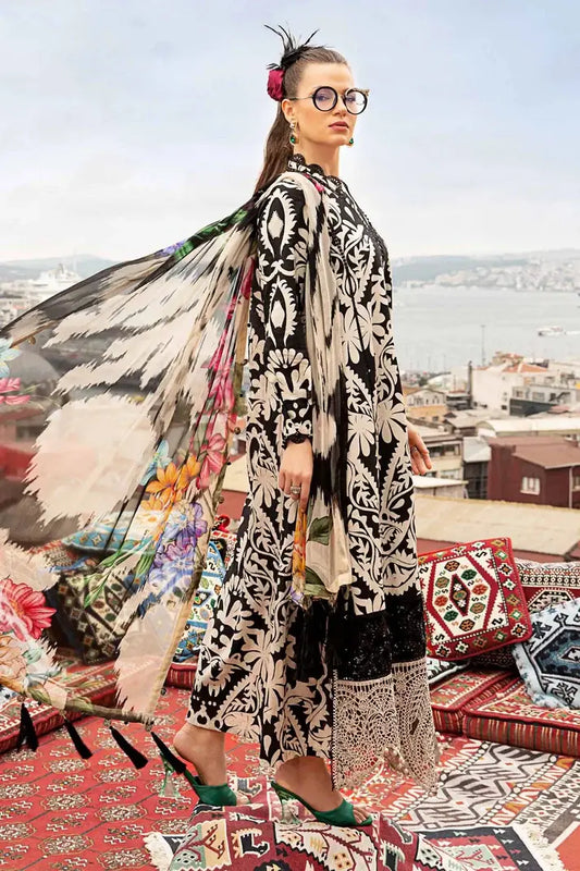 Woman in a patterned outfit with a colorful scarf on a rooftop with cityscape view