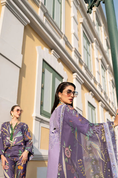 Woman in a purple outfit standing in front of a building