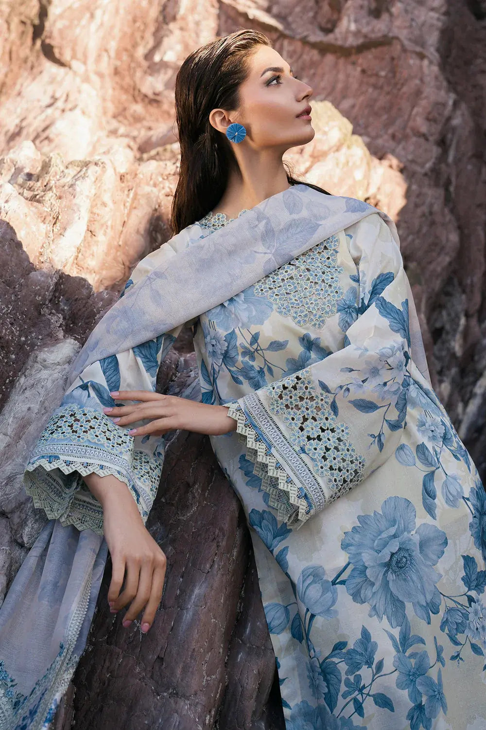 Woman wearing a floral dress with a rocky background