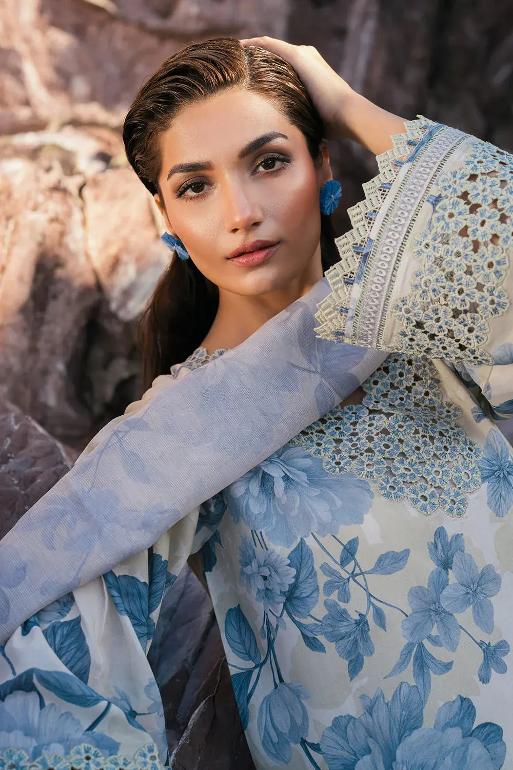 Woman wearing a blue floral dress with a textured background