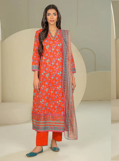 Woman wearing a red floral dress with a matching dupatta in a minimalistic setting
