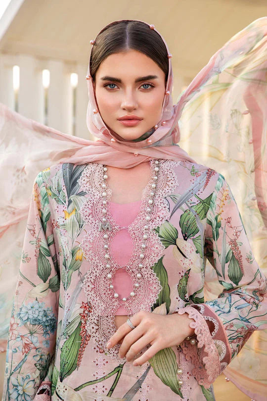 Woman wearing a floral and embroidered outfit with a pink hijab.