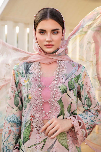 Woman wearing a floral and embroidered outfit with a pink hijab.