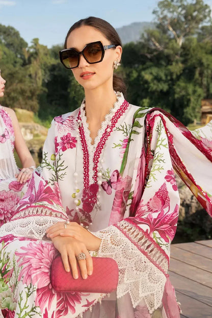 Woman in a floral dress with sunglasses and a pink clutch outdoors.