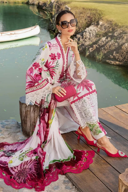Woman in a floral outfit sitting by a lake