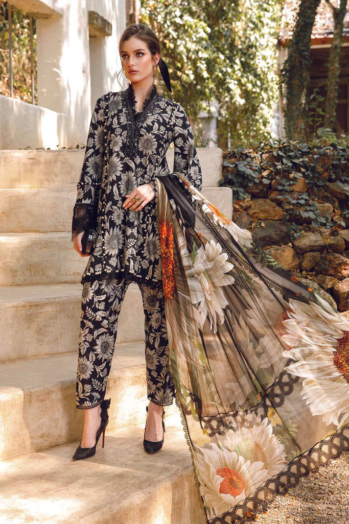 Woman in a floral outfit holding a long scarf outdoors.